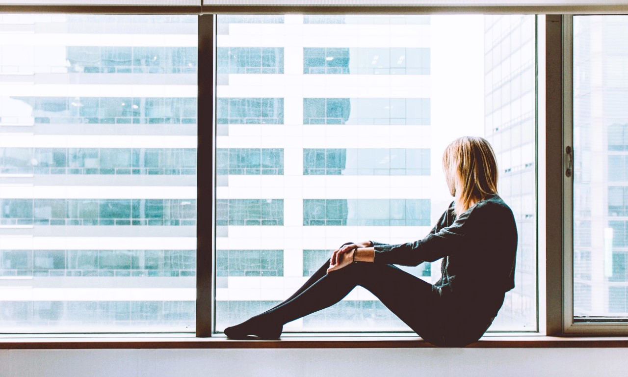 Girl sitting on the windowsill